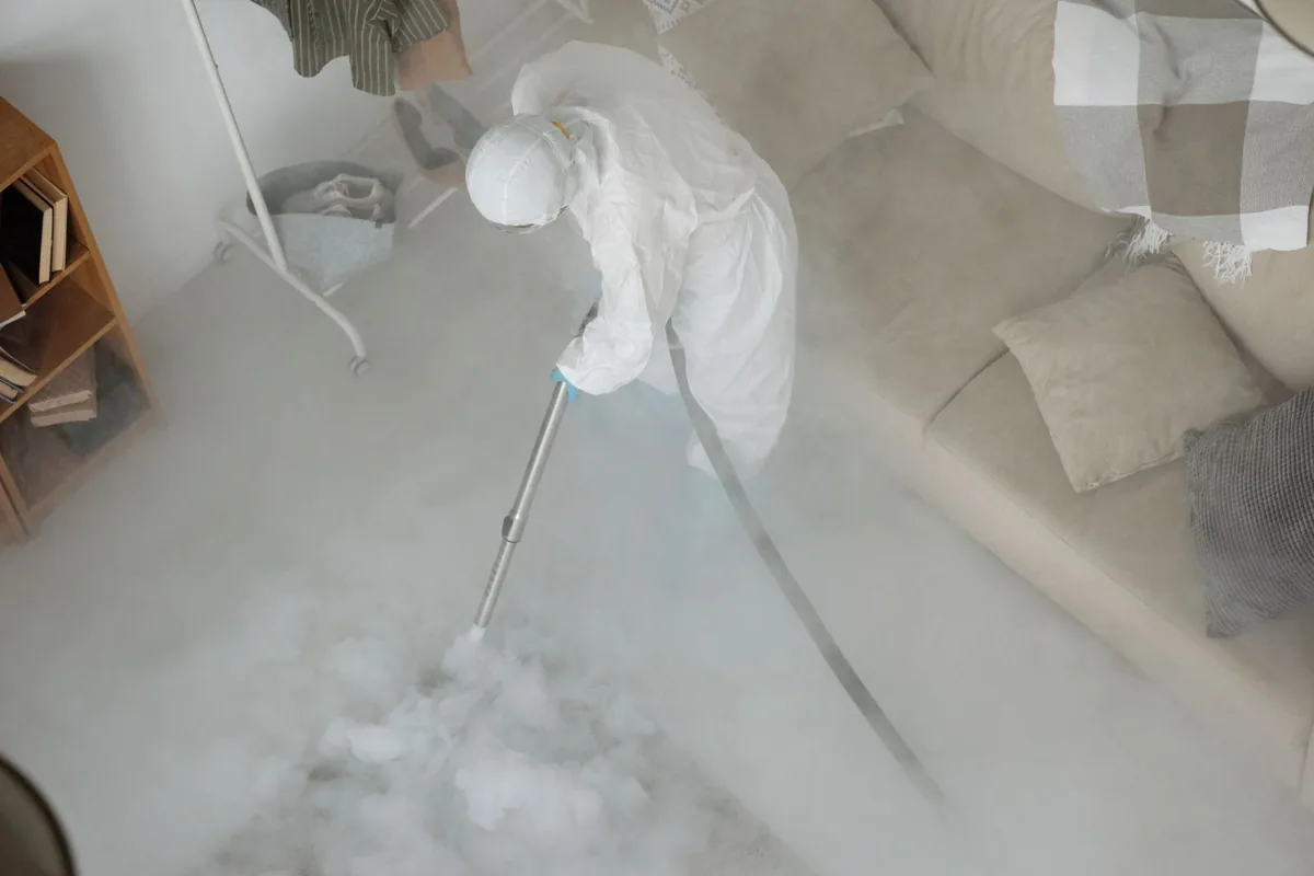 Biohazard cleanup technician in protective equipment, Dane, WI